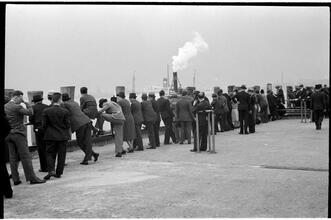 [People waiting on the dock of the Hoboken Ferry Terminal.]