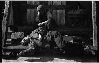 [Destitute men sleeping on pier.]