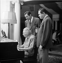 Circus [Two men watching a woman play piano.]