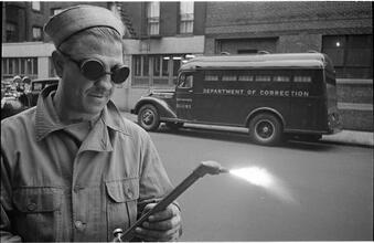 Paddy Wagon [Man with welding equipment used in the making of the television show Paddy Wagon.]