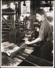 Interior, shoe factory with man at machine