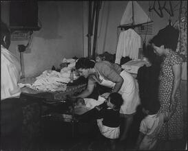 Henry Street Visiting Nurse Service, Checking the Ears of a Chinese Infant.
