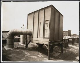 [Factory building, structure on roof.]
