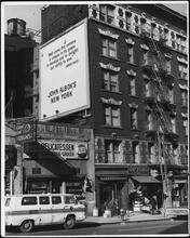 View of [John Albok's] tailor shop at 1392 Madison Avenue with billboard of "John Albok's New York"