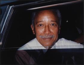 [Mayor David Dinkins looking out of a car window.]