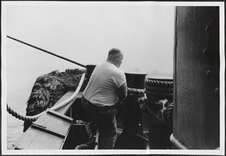 [Crew member working on the ferry.]