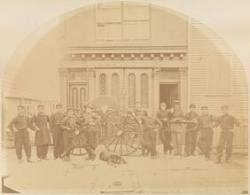 [Firefighters in front of fire truck and Washington Engine Co.]