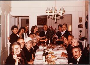[Solomon Shapiro surrounded by his friends at a dinner party.]