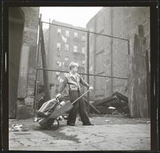 Shoe Shine Boy [Mickey carrying equipment in a wheelbarrow.]