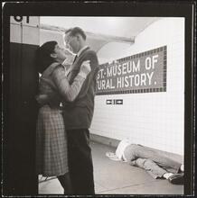 Life and Love on the New York City Subway [Couple on the 81st Street subway platform by a sleeping man.]