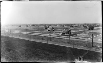 [New land divisions and home construction near the water, with roller coaster at left.]