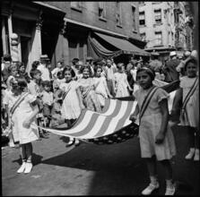 [Girls carrying an American flag.]