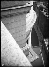 [View looking down from a window to neighboring roofs.]