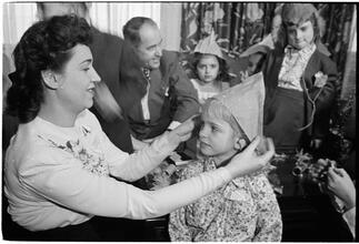 Deaf Children [Teacher putting a party hat on a child.]