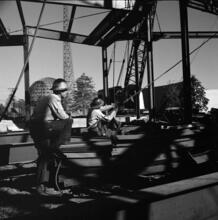 [Construction of the New York World's Fair site, with the steel frames of the Trylon and Perisphere visible in the background.]