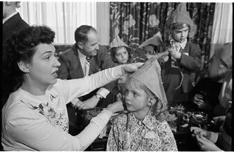 Deaf Children [Teacher putting a party hat on a child.]