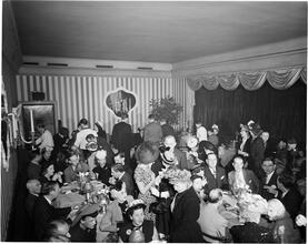 Champagne Cholly Book Party [People socializing at a book party.]