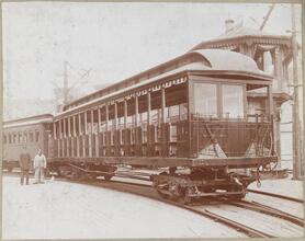 [Railroad workers standing next to train.]