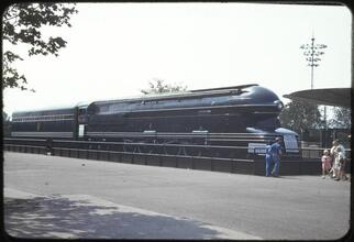 [People looking at trains in the Transportation Zone.]