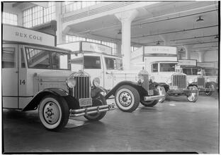 Rex Cole garage. Four large trucks.