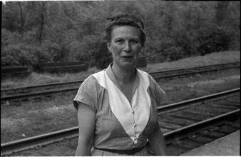 [Unidentified woman next to railroad tracks.]