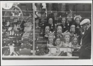 [Women's fashion accessories displayed in store window.]