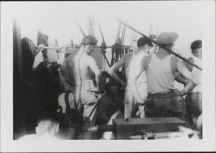 [Crew members on deck of ship.]