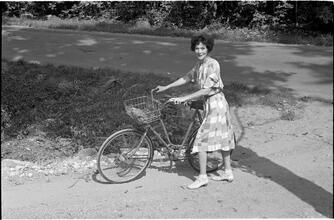 [Unidentified woman with bicycle.]