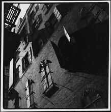 [Unidentified brick building with metal shutters.]