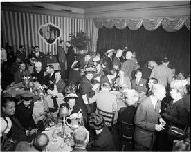 Champagne Cholly Book Party [People socializing at a party.]