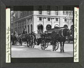 The last stand of the antique carriages of the "Golden Nineties", a strange sight among New York's smart motor traffic.