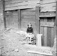 Little Girl in a Cluttered Lot