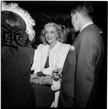 Champagne Cholly Book Party [Man and woman talking.]