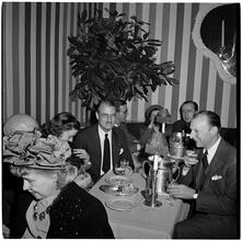 Champagne Cholly Book Party [People socializing at a table.]