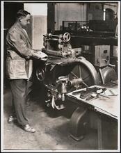 Interior, shoe factory with man at machine