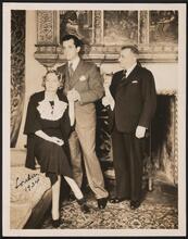 [Three unidentified people in London.]