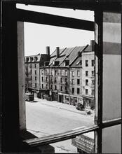 [Looking southeast through a window toward Schermerhorn Row.]