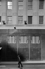 [Woman rollerblading past Bloomingdale's.]