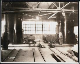 [Interior, manufacturing shop, metal melting furnace oven.]