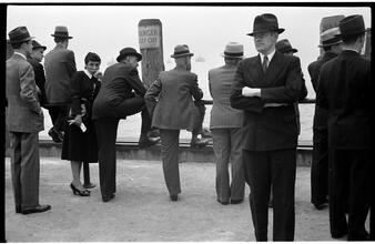 [People waiting on the dock of the Hoboken Ferry Terminal.]