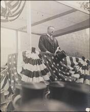 [Teddy Roosevelt addressing the crowd at a parade in his honor.]