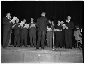 [Men singing.]
