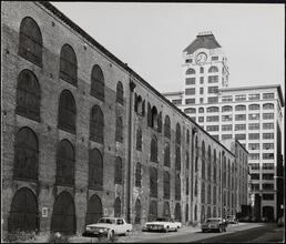 [Empire Stores, 53-83 Water Street, with the clock tower of the Walentas Building in the background.]