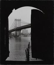 [Looking northeast over the East River from a warehouse window of Empire Stores to Manhattan's Lower East Side.]
