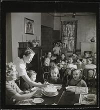 Orphanage [Children eating at tables.]