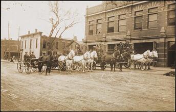 [Various horse-drawn vehicles used by the Fire Department outside of the Central Fire Station.]