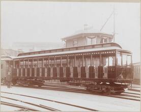 [Railroad worker standing next to train.]