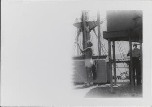 [Crew members working on deck of ship.]