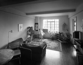 [Man sitting in a residential interior.]