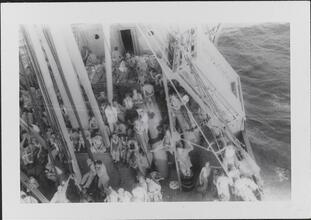 [Crew members on deck of ship.]